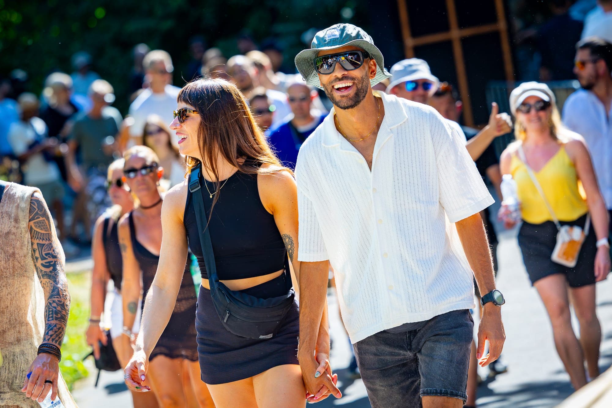 Smiling festivalgoers walking hand in hand at LoveLand Festival in Amsterdam