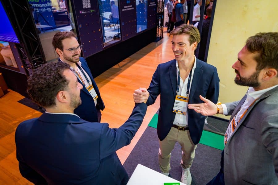 Attendees greeting each other on the DPW Amsterdam expo floor.